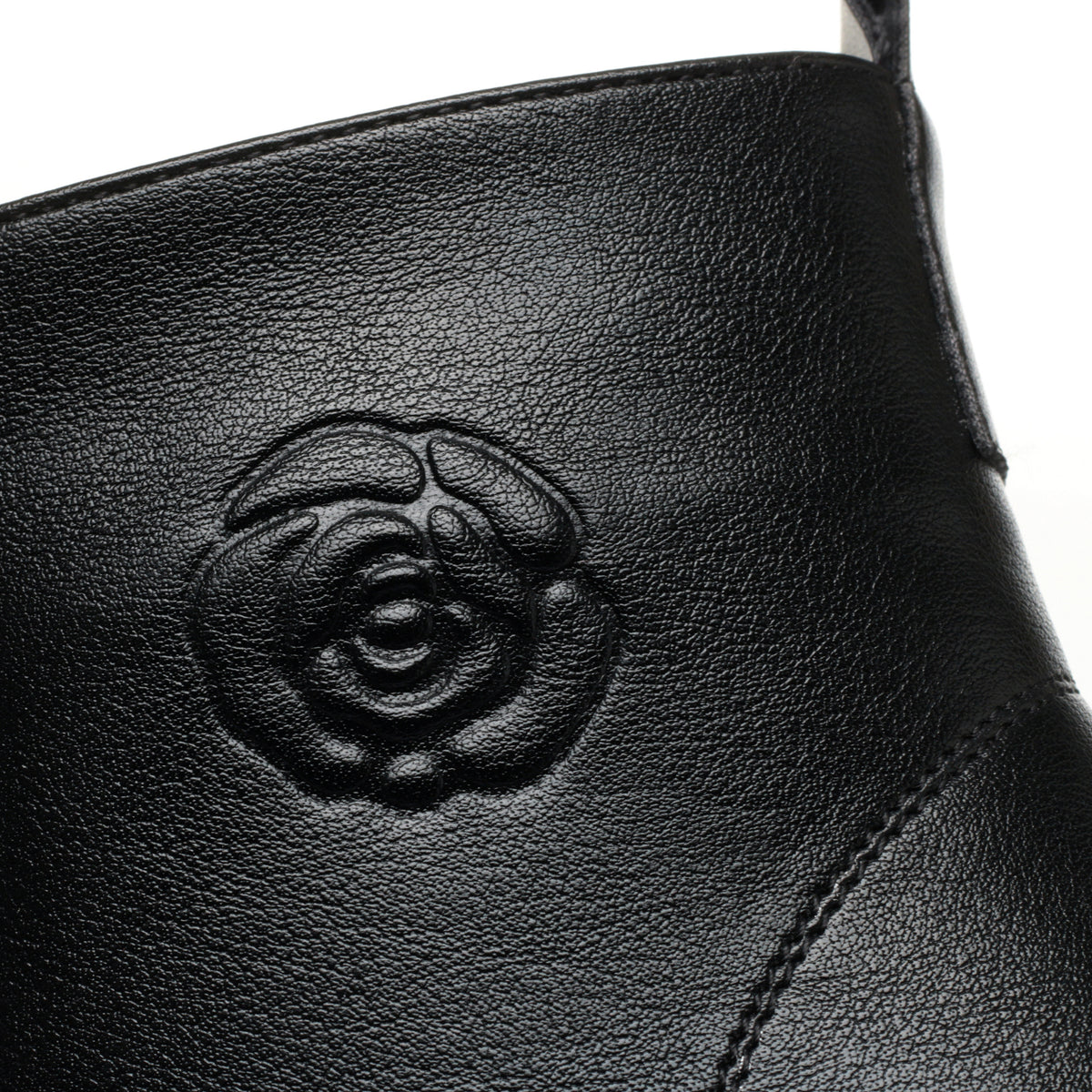 Women's black lace-up ankle boots with flower detail, flower detail close-up